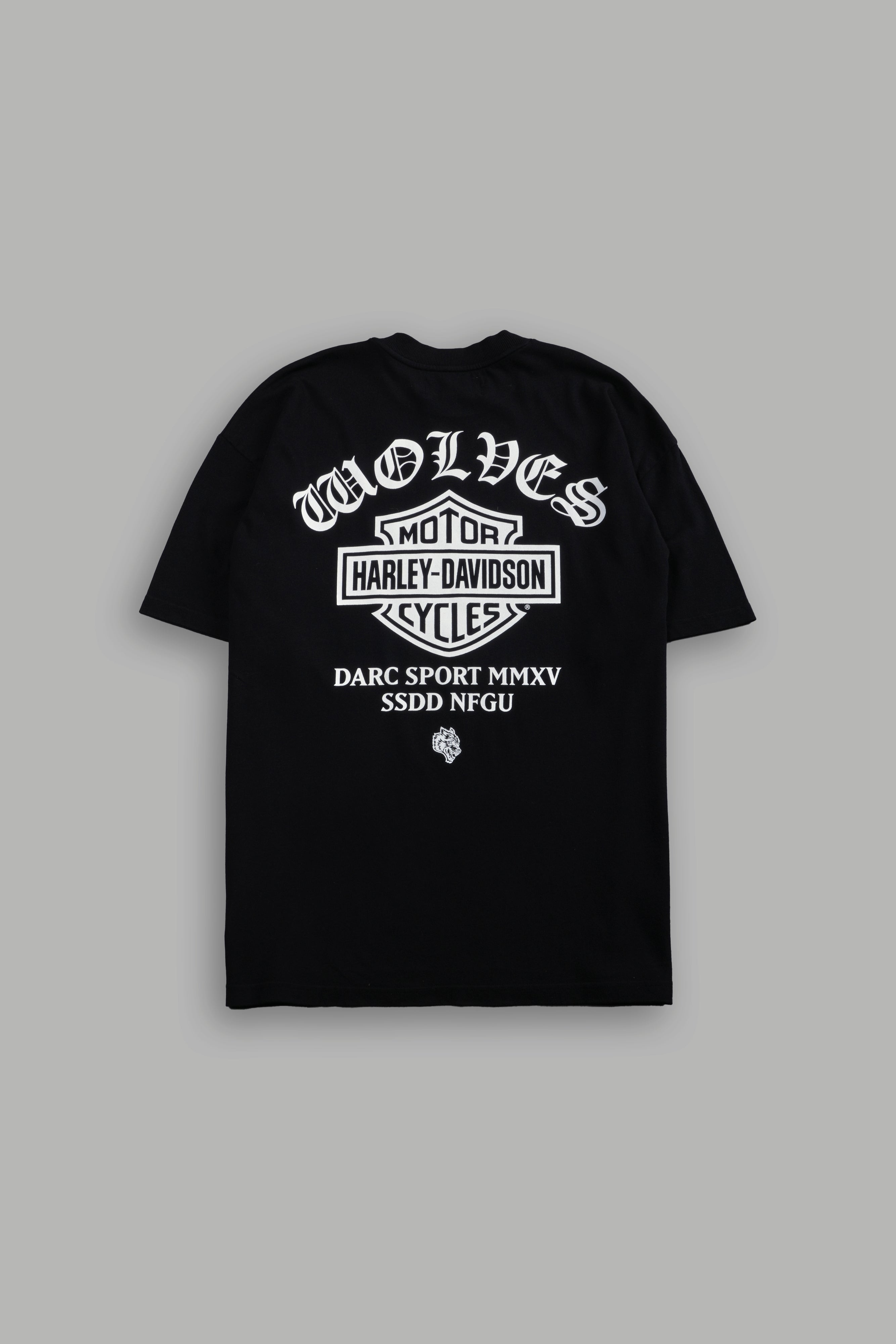 Black t-shirt with white text and graphics on a gray background