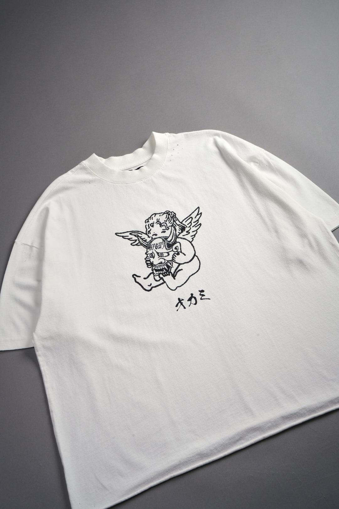 Oni Cherub Distressed Grunge Mid Length Raw Hem Tee in Cream