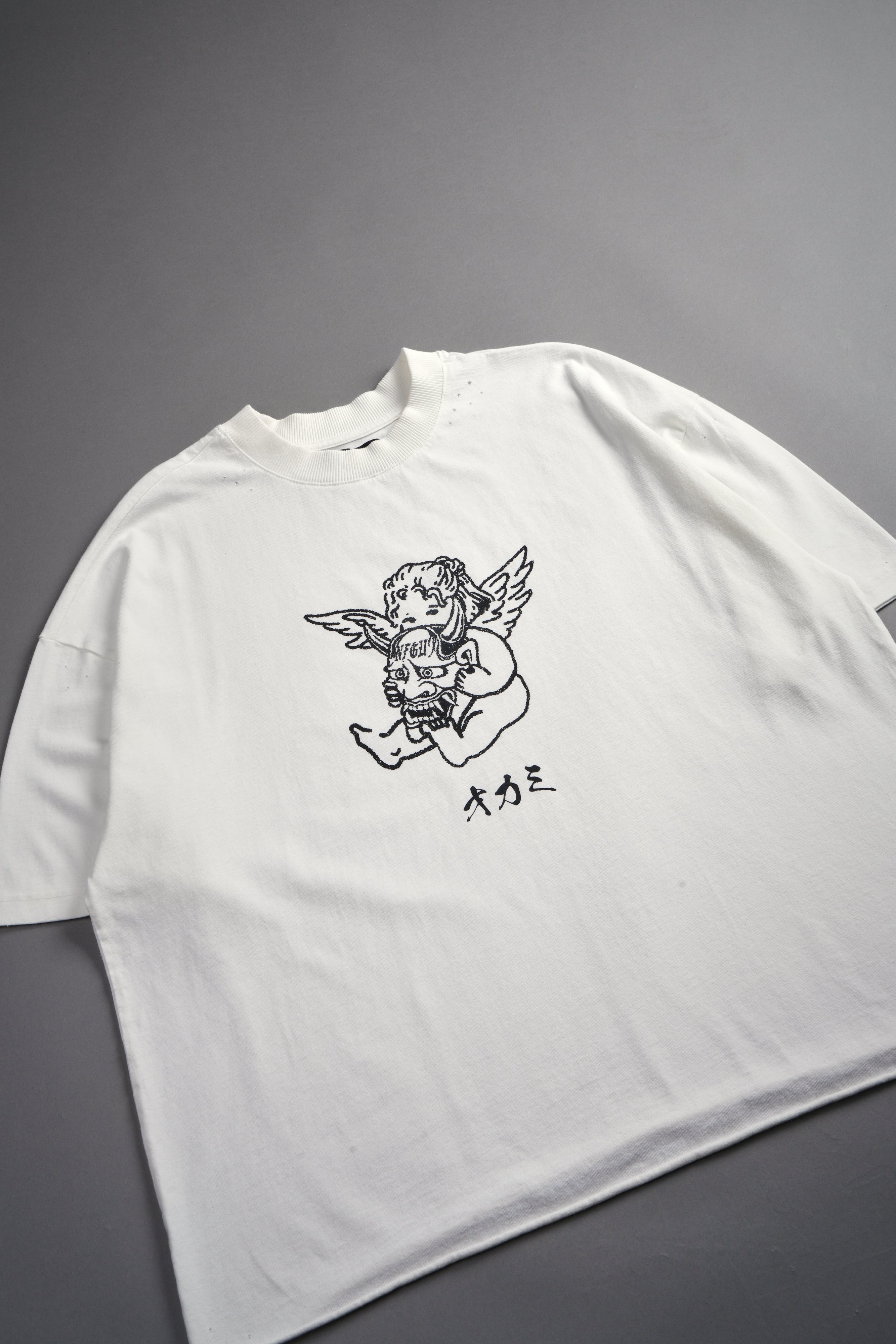 Oni Cherub Distressed Grunge Mid Length Raw Hem Tee in Cream