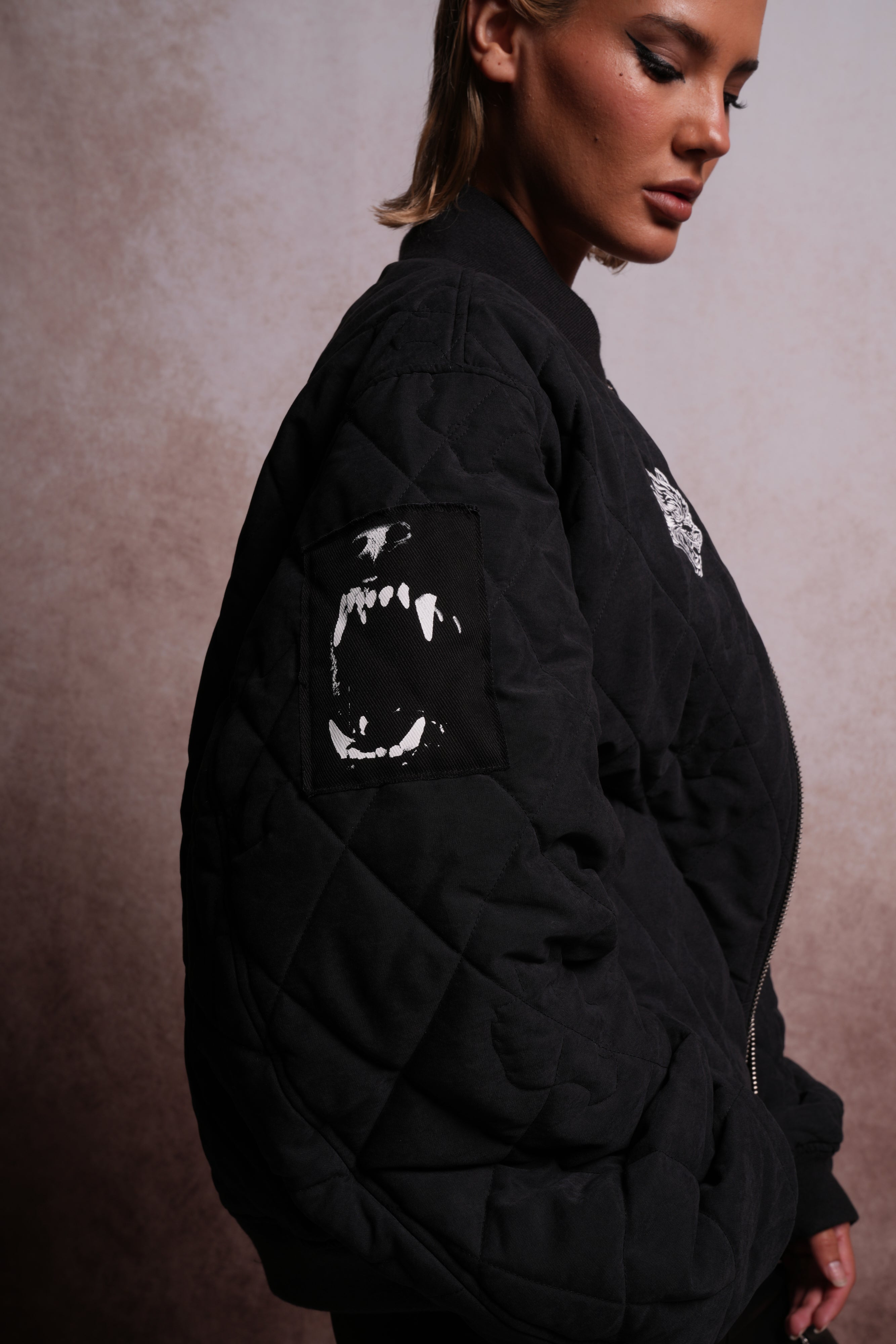 Patched Wolf Hesh Cloud Quilted Reversible Bomber Jacket in Black